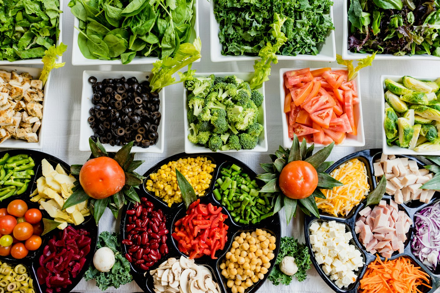Stackable meal-prep containers filled with lunches on a kitchen counter
